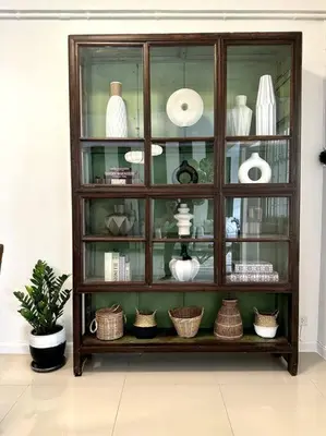 a display cabinet filled with vases and baskets at Oasis townhouse in the perfect location in Bangkok