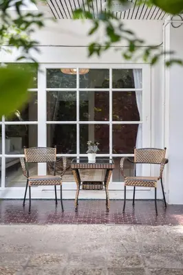 two chairs and a table in front of a window at Oasis townhouse in the perfect location in Bangkok