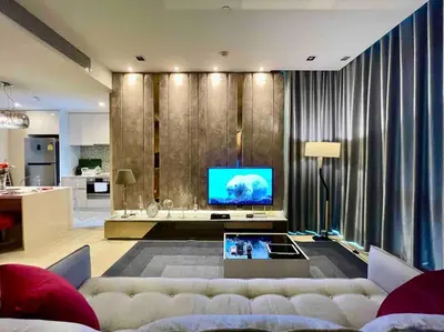 a living room with a couch and a television at Luxurious in Prime Area Bangkok (PickupService) in Bangkok