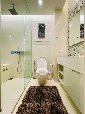a bathroom with a toilet and a glass shower at Luxurious in Prime Area Bangkok (PickupService) in Bangkok