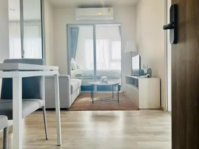 a living room with a couch and a table at Ramkhamhaeng Condo in Bangkok