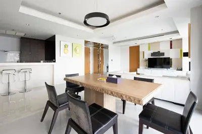 a kitchen and dining room with a wooden table and chairs at M Estate Private Residence 3BR, Heart of Bangkok in Bangkok