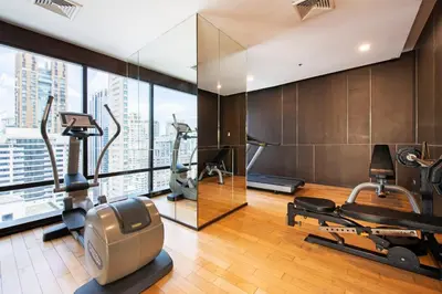 a gym with treadmills and ellipticals in a building at M Estate Private Residence 3BR, Heart of Bangkok in Bangkok