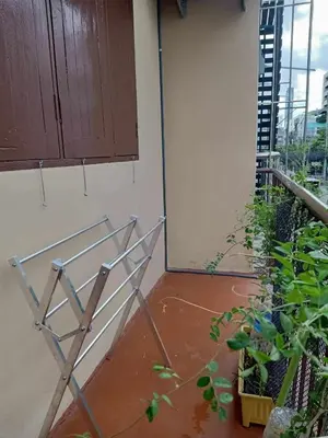 a metal stand in a room with a plant at Be Local BNB in Bangkok