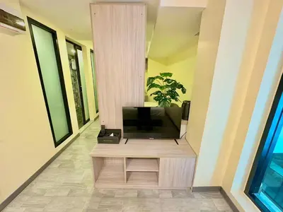 a living room with a television on a table at Nona Hotel, Bangkok in Makkasan