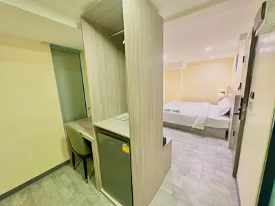 a small room with a bed and a bedroom at Nona Hotel, Bangkok in Makkasan