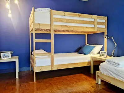 a bedroom with bunk beds and a blue wall at Sukhumvit Boutique Suite : Soi 13/ 10min. from BTS Nana station in Bangkok