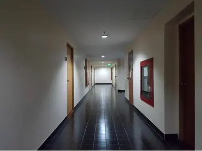 an empty hallway with white walls and a tile floor at Sukhumvit Boutique Suite : Soi 13/ 10min. from BTS Nana station in Bangkok