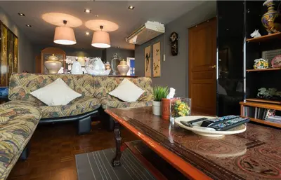 a living room with a couch and a table at Sukhumvit Boutique Suite : Soi 13/ 10min. from BTS Nana station in Bangkok