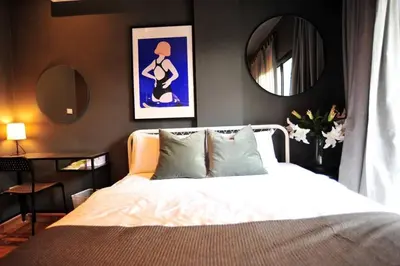 a bedroom with a white bed and a mirror at STAY-DIUM House Huamark in Ban Bang Toei (1)
