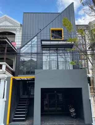 a glass building with a yellow window on top of it at STAY-DIUM House Huamark in Ban Bang Toei (1)