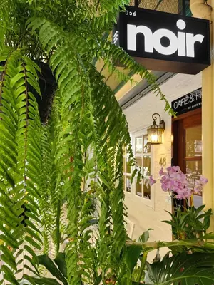 a large green plant in front of a building at Noir Cafe And Hostel Chinatown Bangkok in Chinatown