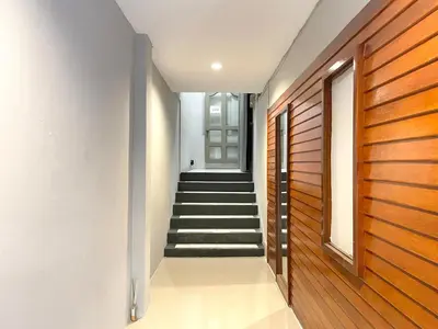 a hallway with a wooden door and stairs at Vélin Khaosan - 3rd Floor apartment with 2Bedrooms in Bangkok