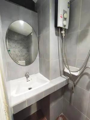 a bathroom with a sink and a mirror at KS HOUSE in Bangkok