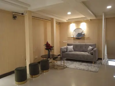 a living room with a couch and a table at KS HOUSE in Bangkok