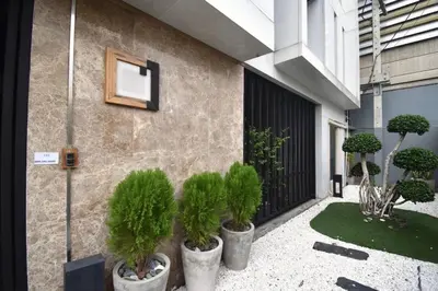 a group of potted plants on the side of a building at BTS 46 - Near BTS Phrakhanong in Bangkok