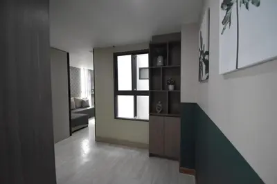 a living room with a window and a room with a couch at BTS 46 - Near BTS Phrakhanong in Bangkok