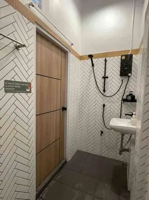 a small bathroom with a sink and a door at Relax in town,Grand Palace in Bangkok