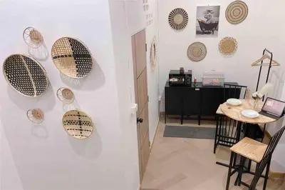 a room with a table and plates on the wall at Relax in town,Grand Palace in Bangkok