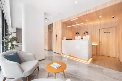 two women standing at a counter in a lobby at LiveZen Bangkok Sukhumvit in Khlong Toei