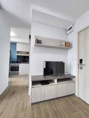 a living room with a flat screen tv on a wall at ABoutNont HOTEL & MANSION in Nonthaburi