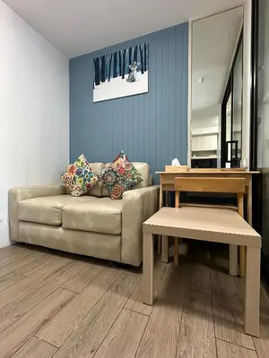 a living room with a couch and a table at ABoutNont HOTEL & MANSION in Nonthaburi