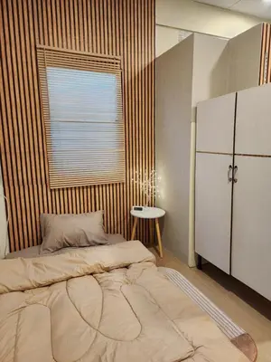a bedroom with a large bed and a window at 205-Olan Place Homely room Free Wi-Fi and Near BTS line in Ban Yang