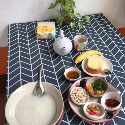a table with a bowl of rice and bowls of food at Worakarn Apartment 3 in Bangkok