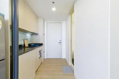 a hallway leading to a kitchen with a door at Loft Pool Superior Suite Near jodd Night Market 500mbps Wi-Fi Twin in Bangkok
