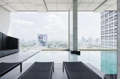 an empty room with a view of a city at Loft Pool Superior Suite Near jodd Night Market 500mbps Wi-Fi Twin in Bangkok