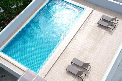 an overhead view of a swimming pool with two chairs at Lucky Elephant Hotel in Ban Bang Toei (1)