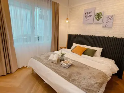 a bedroom with a large bed with shoes on it at Entire floor,Decorated cozy home, near Grand Palace in Bangkok