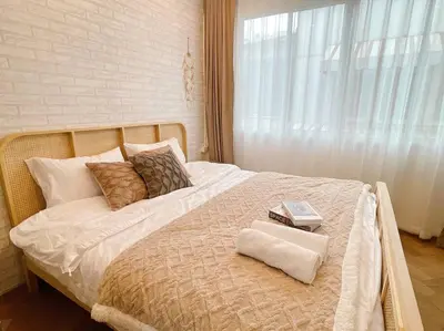 a bedroom with a bed with two books on it at Entire floor,Decorated cozy home, near Grand Palace in Bangkok