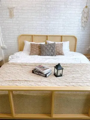 a bed with a book and a lamp on it at Entire floor,Decorated cozy home, near Grand Palace in Bangkok