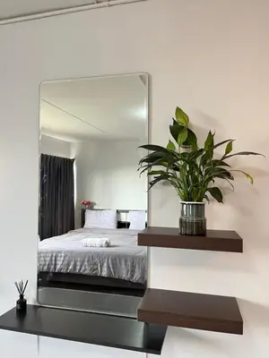 a bedroom with a large mirror on the wall at T12 Popular Condo By : hunnity in Ban Bang Phang