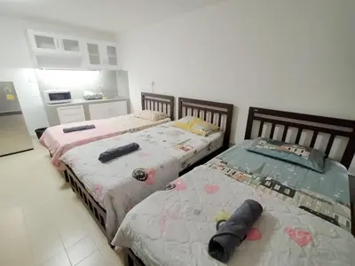 two beds sitting next to each other in a room at Popular The best muangthongthani \u65e5\u5e38\u623f\u95f4\u516c\u5bd3 in Ban Bang Phang