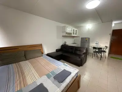 a bedroom with a bed and a couch and a table at Popular The best muangthongthani \u65e5\u5e38\u623f\u95f4\u516c\u5bd3 in Ban Bang Phang