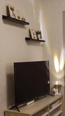 a flat screen tv sitting on top of a table at Elio Del Ray condo feel resort in Bangkok