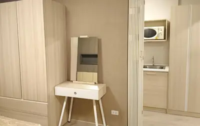 a small kitchen with a sink and a microwave at Elio Del Ray condo feel resort in Bangkok