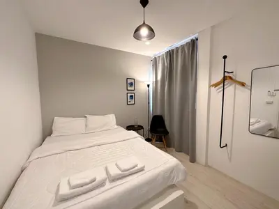 a white bed with two white towels on it at Na Ekkamai Residence in Bangkok