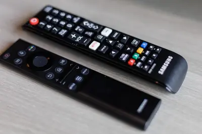 two remote controls sitting on top of a table at Bangkok city center-thong lo-rca-high-rise one-bedroom in Bangkok