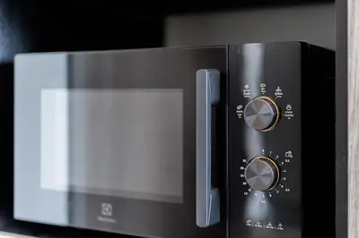 a microwave oven sitting on top of a counter at Bangkok city center-thong lo-rca-high-rise one-bedroom in Bangkok