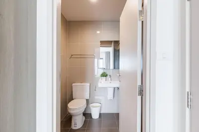a small bathroom with a toilet and a sink at 2 bedrooms -1 living room and 1 bathroom - swimming pool in Ban Rang Sai (2)