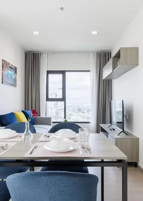 a dining room with a table and blue chairs at 2 bedrooms -1 living room and 1 bathroom - swimming pool in Ban Rang Sai (2)