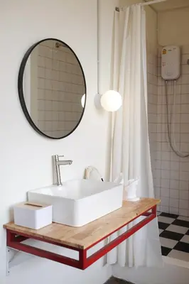 a bathroom with a white sink and a mirror at SANT Bangkok at Khaosan Road in Bangkok