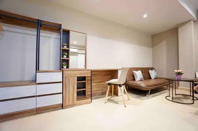 a living room with a couch and a table at Maruay Living Apartment (Khaosan/Chinatown/Samyot MRT) in Bangkok