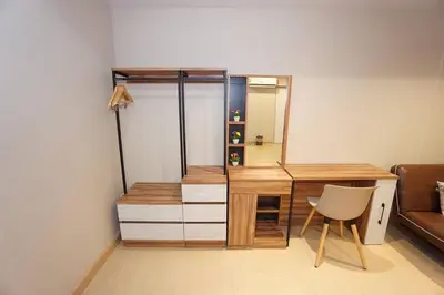 a desk with a mirror and a chair in a room at Maruay Living Apartment (Khaosan/Chinatown/Samyot MRT) in Bangkok