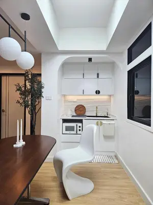 a kitchen with a table and a white chair at PB home 1 min to BTS Saladaeng & MRT Silom in Bang Rak