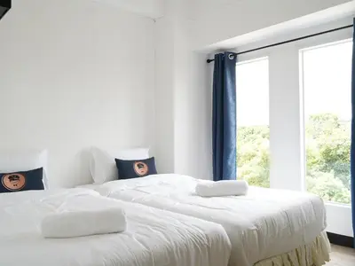 two white beds in a room with a window at RoomQuest IT Square Don Mueang Airport in Bangkok