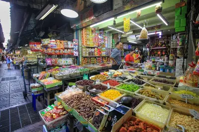 a market filled with lots of different fruits and vegetables at The Character Yaowarat เดอะคาแลตเตอร์ เยาวราช in Khlong San